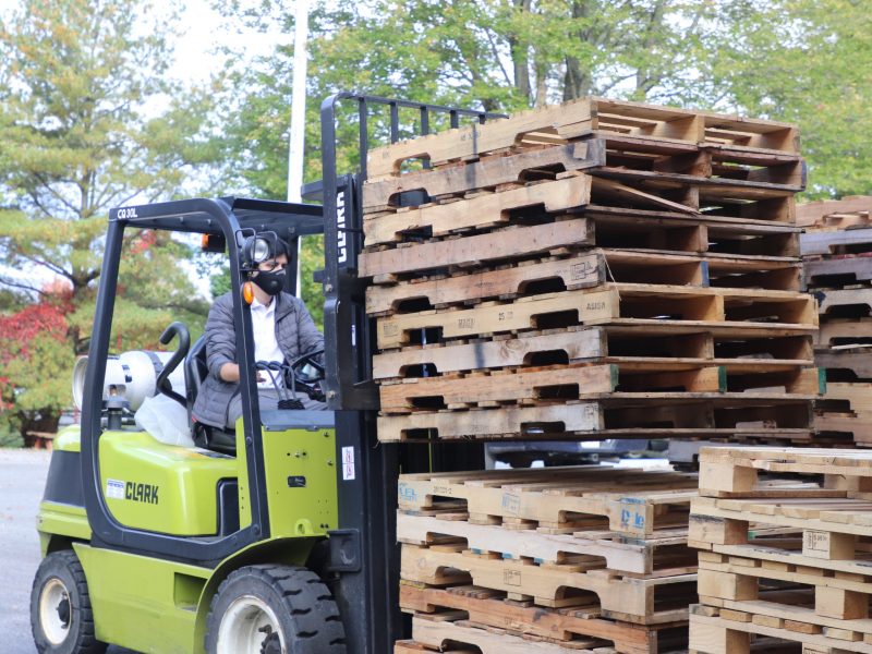 Image 1. Jorge Masis organizing pallets received from pallet recycling companies.
