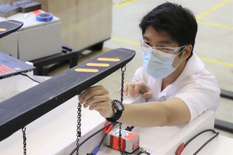 Image 1. Yu Yang setting up his experiment by attaching string potentiometers  to a custom fork tine jig on the lab vibration table.